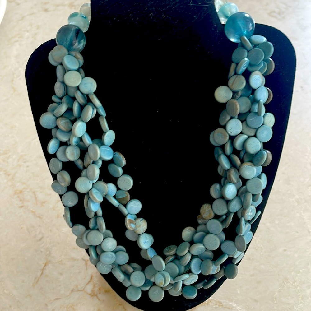 Pretty blue coin beads on silk cord. Button loop closure.